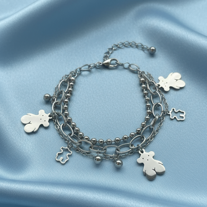 Teddy bear bracelet on baby blue satin background