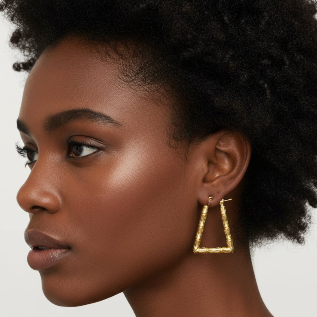 Afro model wearing gold trapezoid bamboo earrings