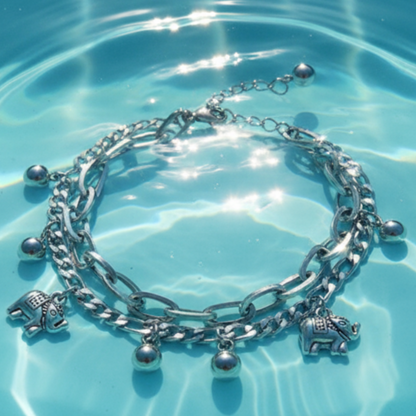 Elephant charm bracelet in pool water with sunlight