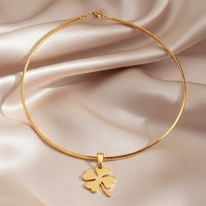 Gold Clover Necklace on Satin Background
