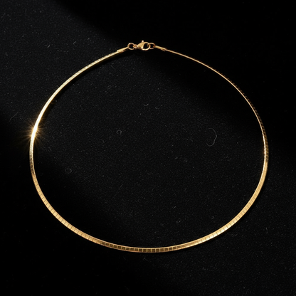 Gold omega chain on black velvet
