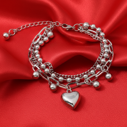 Heart charm bracelet on bright red satin background