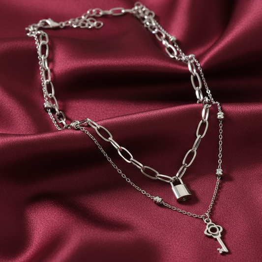 Lock and key necklaces on satin background