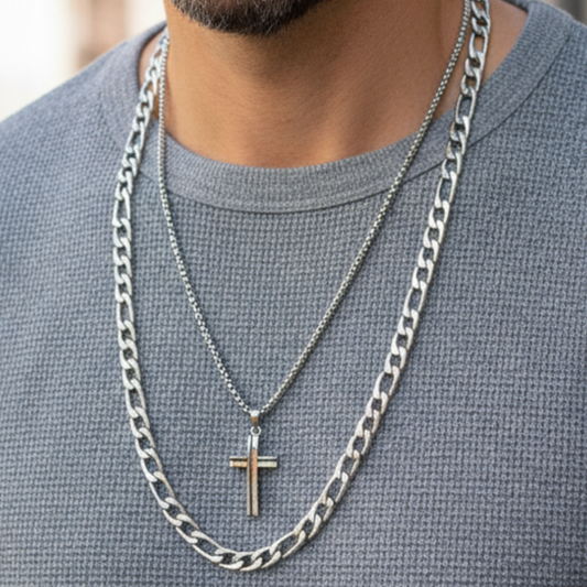 Mature Latin male model wearing layered necklace set with two-tone silver cross