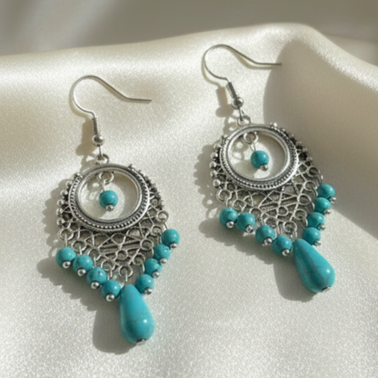 Pair of Turquoise Earrings on Cream Satin