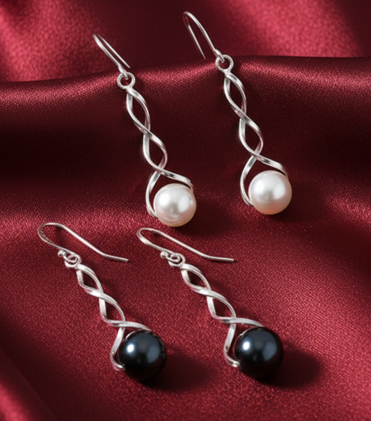 Pearl earrings on dark red satin background