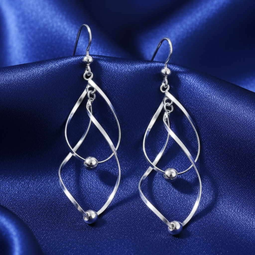 Twisted earrings on blue satin