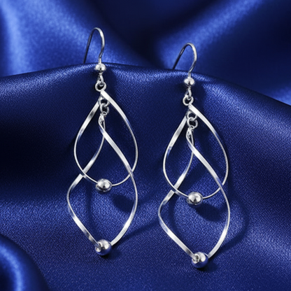 Twisted earrings on blue satin