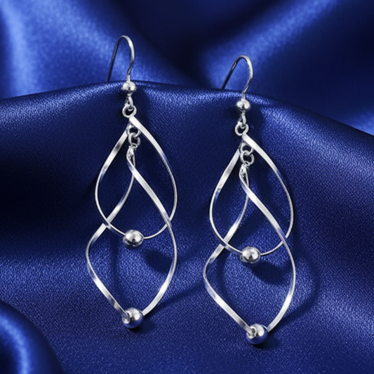 Twisted earrings on blue satin